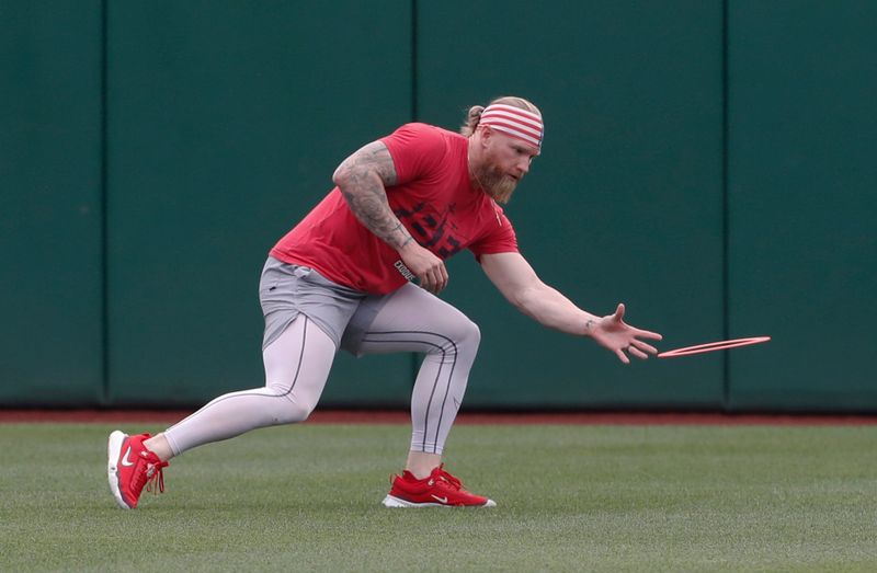 Jun 19, 2024; Pittsburgh, Pennsylvania, USA;  Cincinnati Reds outfielder Jake Fraley (27) warms up with an Aerobie  ring before the game against  the Pittsburgh Pirates at PNC Park. Mandatory Credit: Charles LeClaire-USA TODAY Sports