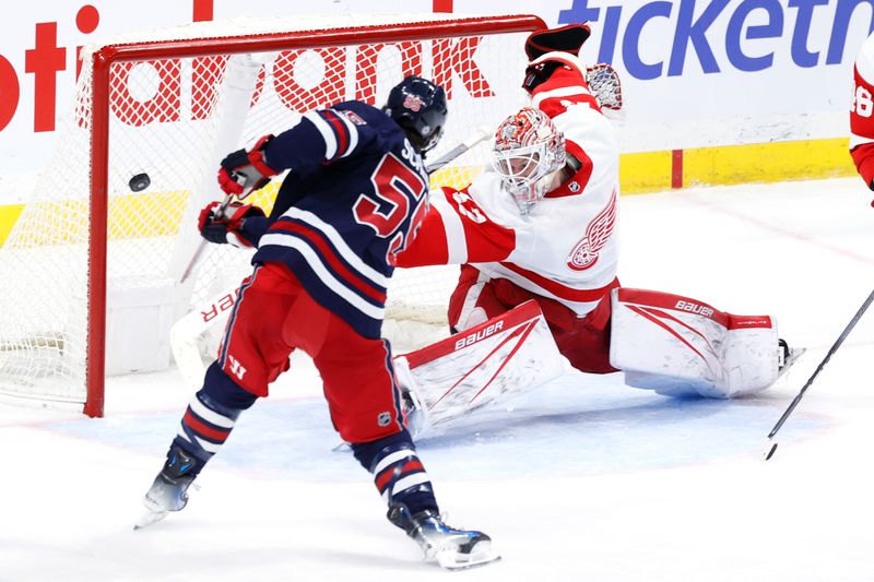 Dec 20, 2023; Winnipeg, Manitoba, CAN; Winnipeg Jets center Mark Scheifele (55) scores on Detroit Red Wings goaltender James Reimer (47) in the third period at Canada Life Centre. Mandatory Credit: James Carey Lauder-USA TODAY Sports