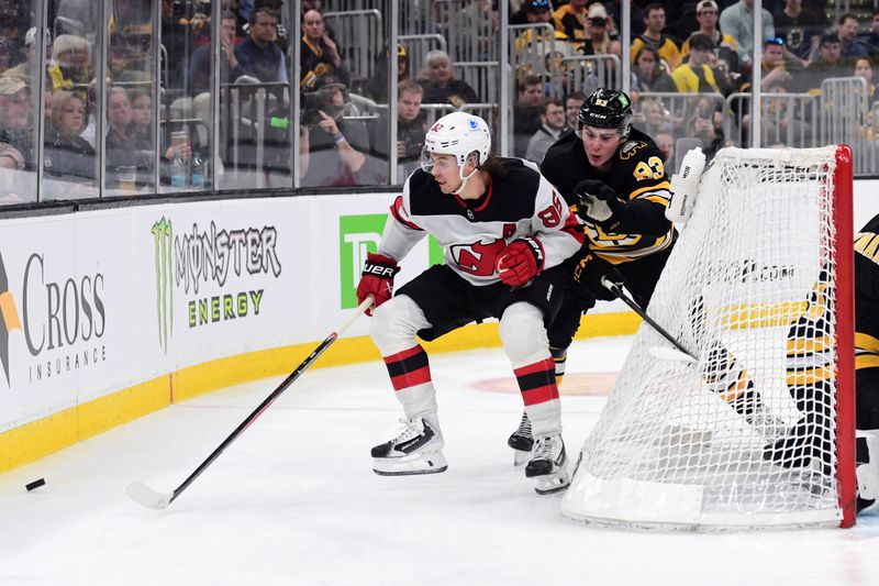 Apr 14, 2026; Boston, Massachusetts, USA; New Jersey Devils center Jack Hughes (86) and Boston Bruins center Fraser Minten (93) battle for the puck during the second period at TD Garden. Mandatory Credit: Bob DeChiara-Imagn Images