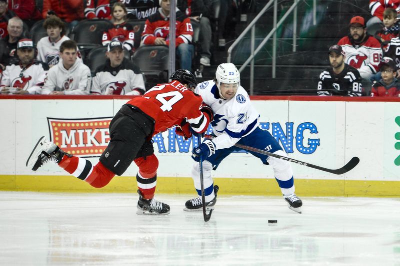 Feb 25, 2024; Newark, New Jersey, USA; Tampa Bay Lightning center Michael Eyssimont (23) skates with the puck while being defended by New Jersey Devils defenseman Colin Miller (24) during the first period at Prudential Center. Mandatory Credit: John Jones-USA TODAY Sports