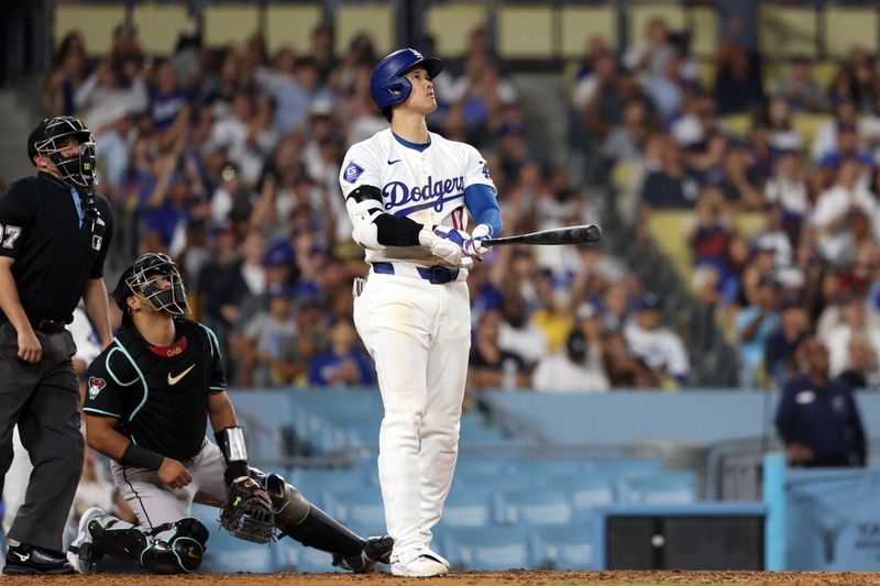 Jul 2, 2024; Los Angeles, California, USA;  Los Angeles Dodgers designated hitter Shohei Ohtani (17) hits a two-run home run during the seventh inning against the Arizona Diamondbacks at Dodger Stadium. Mandatory Credit: Kiyoshi Mio-USA TODAY Sports