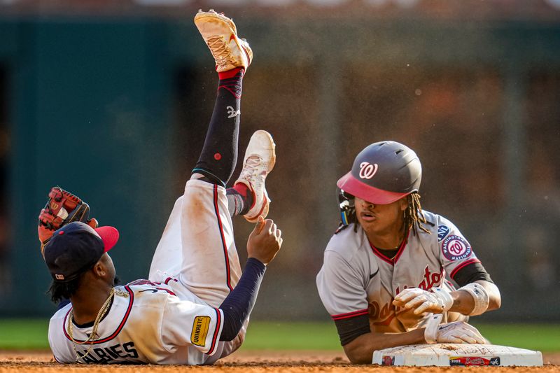 Oct 1, 2023; Cumberland, Georgia, USA; Washington Nationals shortstop CJ Abrams (5) collides with Atlanta Braves second baseman Ozzie Albies (1) after stealing second base during the eighth inning at Truist Park. Mandatory Credit: Dale Zanine-USA TODAY Sports