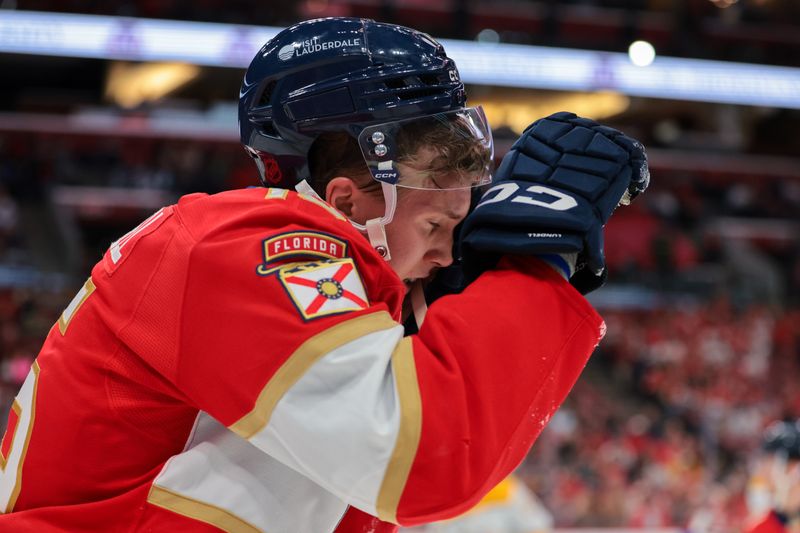Dec 4, 2025; Sunrise, Florida, USA; Florida Panthers center Anton Lundell (15) covers his face after getting hit with a high stick against the Nashville Predators during the second period at Amerant Bank Arena. Mandatory Credit: Sam Navarro-Imagn Images