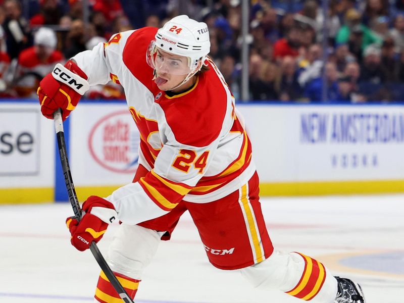 Nov 9, 2024; Buffalo, New York, USA;  Calgary Flames defenseman Jake Bean (24) takes a shot on goal during the third period against the Buffalo Sabres at KeyBank Center. Mandatory Credit: Timothy T. Ludwig-Imagn Images