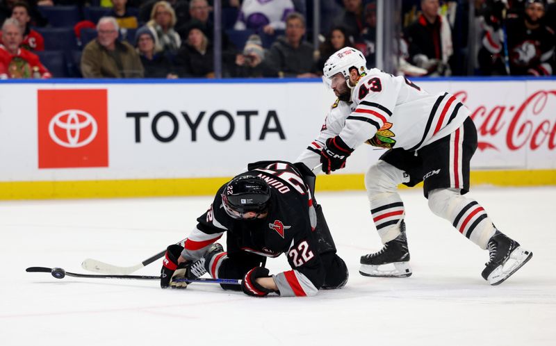 Jan 18, 2024; Buffalo, New York, USA;  Chicago Blackhawks center Colin Blackwell (43) knocks down Buffalo Sabres right wing Jack Quinn (22) as he looks to control the puck during the second period at KeyBank Center. Mandatory Credit: Timothy T. Ludwig-USA TODAY Sports