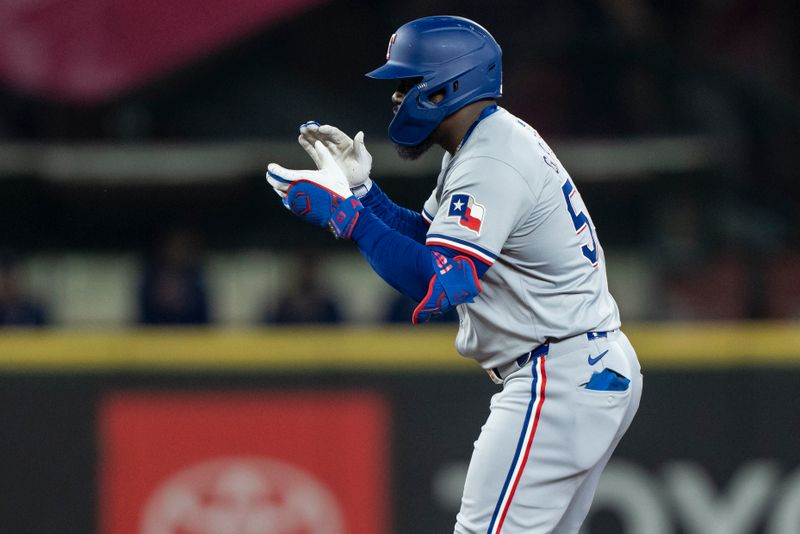 Jun 14, 2024; Seattle, Washington, USA; Texas Rangers right fielder Adolis Garcia (53) celebrates at second base after hitting a double during the sixth inning against the Seattle Mariners at T-Mobile Park. Mandatory Credit: Stephen Brashear-USA TODAY Sports