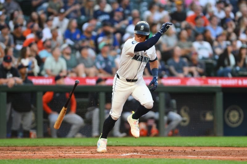 Aug 7, 2024; Seattle, Washington, USA; Seattle Mariners third baseman Dylan Moore (25) throws his bat after hitting a pop fly against the Detroit Tigers during the fifth inning at T-Mobile Park. Mandatory Credit: Steven Bisig-USA TODAY Sports