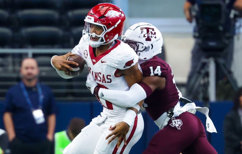 Sep 28, 2024; Arlington, Texas, USA;  Texas A&M Aggies defensive back Jayvon Thomas (14) tackles Arkansas Razorbacks quarterback Taylen Green (10) during the first half at AT&T Stadium. Mandatory Credit: Kevin Jairaj-Imagn Images