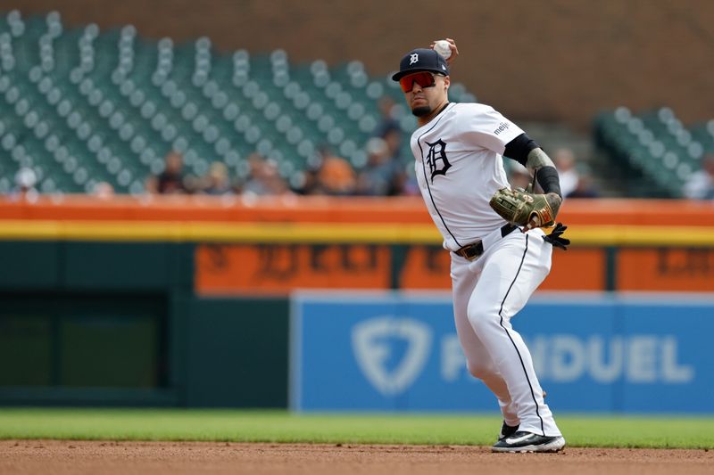 Aug 15, 2024; Detroit, Michigan, USA;  Detroit Tigers shortstop Javier Baez (28) makes a throw against the Seattle Mariners in the first inning at Comerica Park. Mandatory Credit: Rick Osentoski-USA TODAY Sports