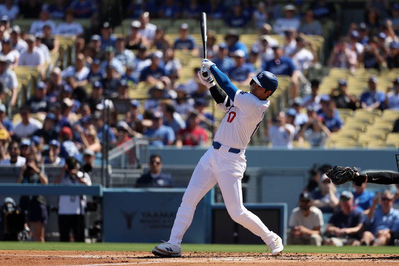 Sep 22, 2024; Los Angeles, California, USA;  Los Angeles Dodgers designated hitter Shohei Ohtani (17) hits a single during the first inning against the Colorado Rockies at Dodger Stadium. Mandatory Credit: Kiyoshi Mio-Imagn Images