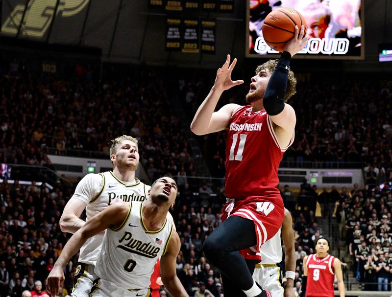 Feb 15, 2025; West Lafayette, Indiana, USA; Wisconsin Badgers guard Max Klesmit (11) shoots the ball in front of Purdue Boilermakers guard C.J. Cox (0) during the first half at Mackey Arena. Mandatory Credit: Marc Lebryk-Imagn Images