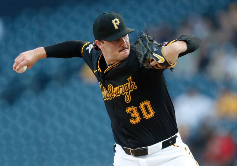 Aug 22, 2024; Pittsburgh, Pennsylvania, USA;  Pittsburgh Pirates starting pitcher Paul Skenes (30) delivers a pitch against the Cincinnati Reds during the first inning at PNC Park. Mandatory Credit: Charles LeClaire-USA TODAY Sports