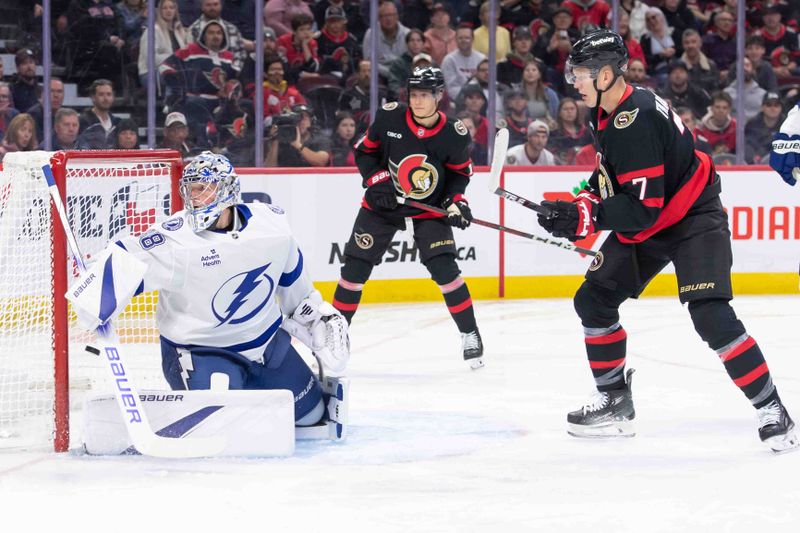 Oct 19, 2024; Ottawa, Ontario, CAN; Ottawa Senators center Josh Norris (9-not pictured) scores against Tampa Bay Lightning goalie Andrei Vasilevskiy (88) as Senators center Tim Stuzle (18) and left wing Brady Tkachuk (7) look on in the first period at the Canadian Tire Centre. Mandatory Credit: Marc DesRosiers-Imagn Images