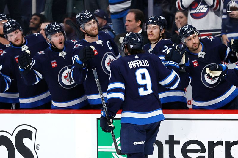 Jan 2, 2024; Winnipeg, Manitoba, CAN; Winnipeg Jets left wing Alex Iafallo (9) celebrates his second period goal against the Tampa Bay Lightning at Canada Life Centre. Mandatory Credit: James Carey Lauder-USA TODAY Sports