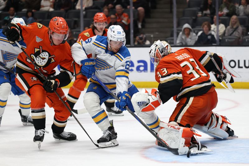 Mar 8, 2026; Anaheim, California, USA;  St. Louis Blues center Pius Suter (22) fights for the puck against Anaheim Ducks goaltender Ville Husso (33) during the third period at Honda Center. Mandatory Credit: Kiyoshi Mio-Imagn Images