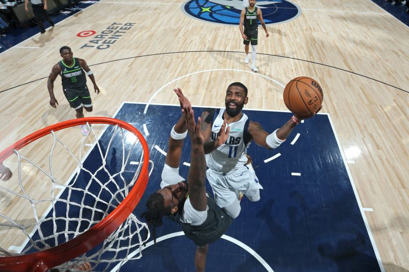 MINNEAPOLIS, MN - MAY 30: Kyrie Irving #11 of the Dallas Mavericks drives to the basket during the game  against the Minnesota Timberwolves during Game 5 of the Western Conference Finals during the 2024 NBA Playoffs on May 30, 2024 at Target Center in Minneapolis, Minnesota. NOTE TO USER: User expressly acknowledges and agrees that, by downloading and or using this Photograph, user is consenting to the terms and conditions of the Getty Images License Agreement. Mandatory Copyright Notice: Copyright 2024 NBAE (Photo by David Sherman/NBAE via Getty Images)