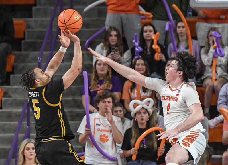 Feb 27, 2024; Clemson, South Carolina, USA; Clemson junior forward Ian Schieffelin (4) defends a shot by Pitt guard Ishmael Leggett (5) during the second half at Littlejohn Coliseum. Mandatory Credit: Ken Ruinard-USA TODAY Sports