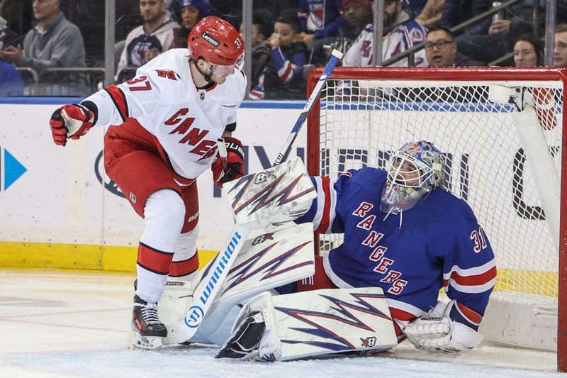 Jan 28, 2025; New York, New York, USA;  Carolina Hurricanes right wing Andrei Svechnikov (37) gets up off the ice after colliding with New York Rangers goaltender Igor Shesterkin (31) in the second period at Madison Square Garden. Mandatory Credit: Wendell Cruz-Imagn Images