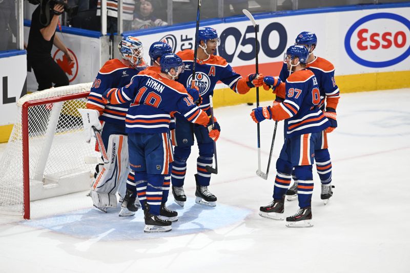 Apr 9, 2025; Edmonton, Alberta, CAN; Edmonton Oilers goalie Calvin Pickard (30) celebrates with defenseman Darnell Nurse (25), left wing Zach Hyman (18) and center Connor McDavid (97) after defeating the St. Louis Blues at Rogers Place. Mandatory Credit: Walter Tychnowicz-Imagn Images