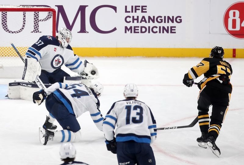 Nov 22, 2024; Pittsburgh, Pennsylvania, USA; Winnipeg Jets goaltender Connor Hellebuyck (37) makes a glove save against Pittsburgh Penguins right wing Rickard Rakell (67) during the second period at PPG Paints Arena. Mandatory Credit: Charles LeClaire-Imagn Images