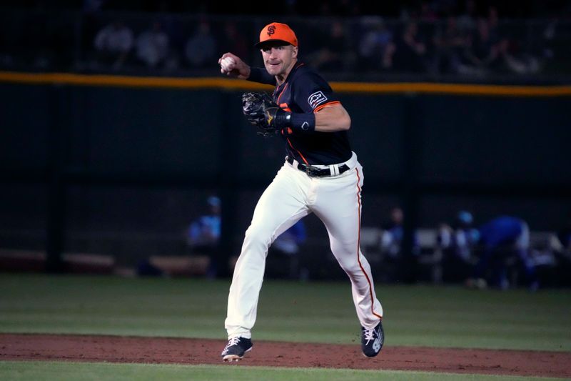 Mar 19, 2024; Scottsdale, Arizona, USA; San Francisco Giants shortstop Nick Ahmed (40)  makes the play against the Kansas City Royals in the second inning at Scottsdale Stadium. Mandatory Credit: Rick Scuteri-USA TODAY Sports