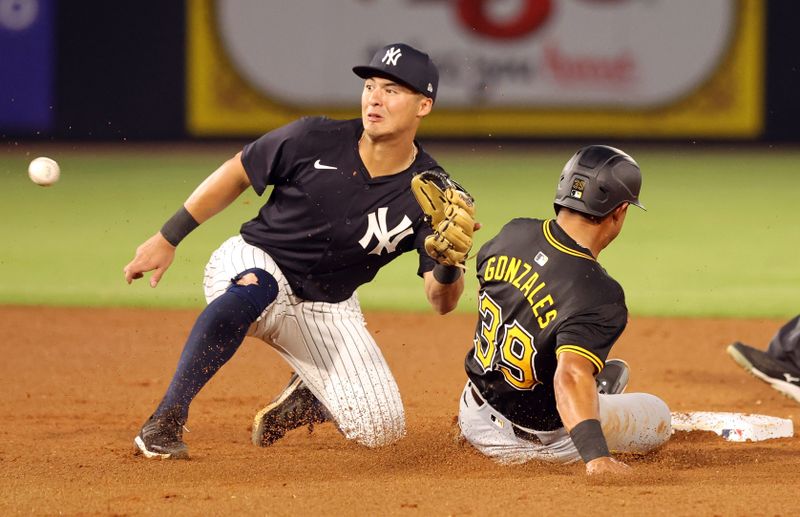 Mar 15, 2024; Tampa, Florida, USA; New York Yankees shortstop Anthony Volpe (11) tags out Pittsburgh Pirates second baseman Nick Gonzales (39) during the fifth inning at George M. Steinbrenner Field. Mandatory Credit: Kim Klement Neitzel-USA TODAY Sports