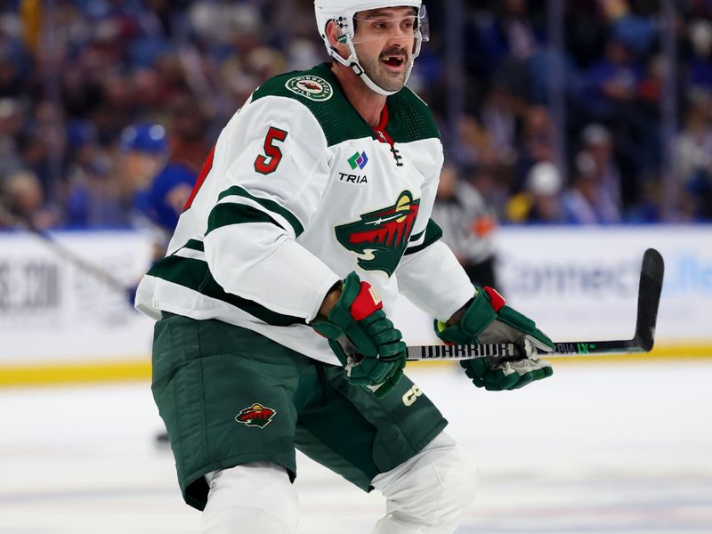 Nov 10, 2023; Buffalo, New York, USA;  Minnesota Wild defenseman Jake Middleton (5) looks for the puck during the second period against the Buffalo Sabres at KeyBank Center. Mandatory Credit: Timothy T. Ludwig-USA TODAY Sports