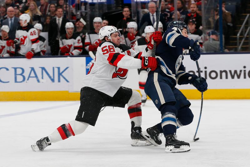 Jan 19, 2024; Columbus, Ohio, USA; Columbus Blue Jackets Forward Cole Sillinger (4) shoots as New Jersey Devils left wing Erik Haula (56) trails the play during the first period at Nationwide Arena. Mandatory Credit: Russell LaBounty-USA TODAY Sports