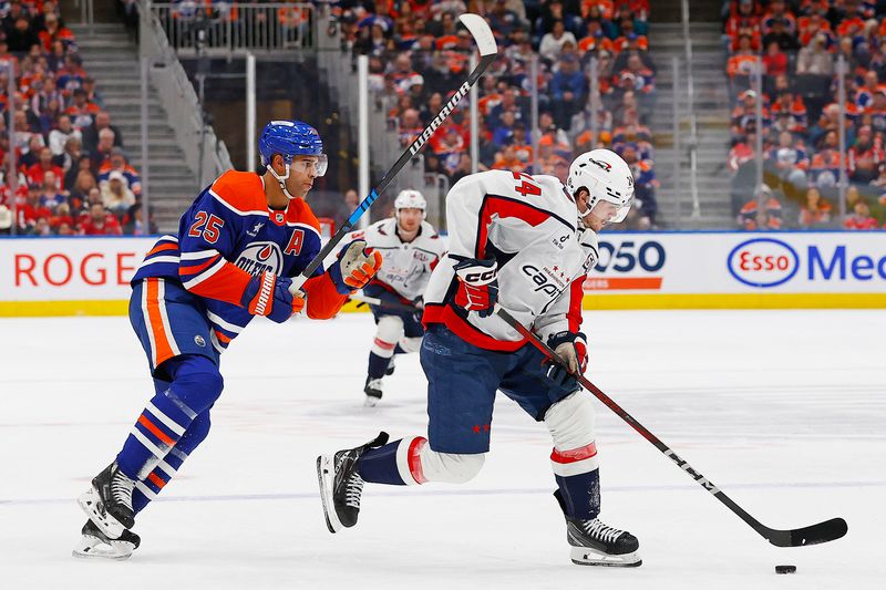 Jan 21, 2025; Edmonton, Alberta, CAN; Washington Capitals forward Connor McMichael (24) moves the puck around Edmonton Oilers defensemen Darnell Nurse (25) during the second period at Rogers Place. Mandatory Credit: Perry Nelson-Imagn Images