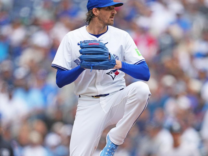 Jun 30, 2024; Toronto, Ontario, CAN; Toronto Blue Jays starting pitcher Kevin Gausman (34) throws a pitch game against the New York Yankees during the first inning at Rogers Centre. Mandatory Credit: Nick Turchiaro-USA TODAY Sports