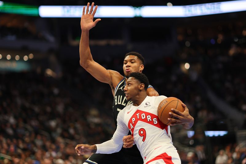 MILWAUKEE, WISCONSIN - NOVEMBER 12: RJ Barrett #9 of the Toronto Raptors drives to the basket against Giannis Antetokounmpo #34 of the Milwaukee Bucks during the first half of a game in the NBA Emirates Cup at Fiserv Forum on November 12, 2024 in Milwaukee, Wisconsin. NOTE TO USER: User expressly acknowledges and agrees that, by downloading and or using this photograph, User is consenting to the terms and conditions of the Getty Images License Agreement. (Photo by Stacy Revere/Getty Images)