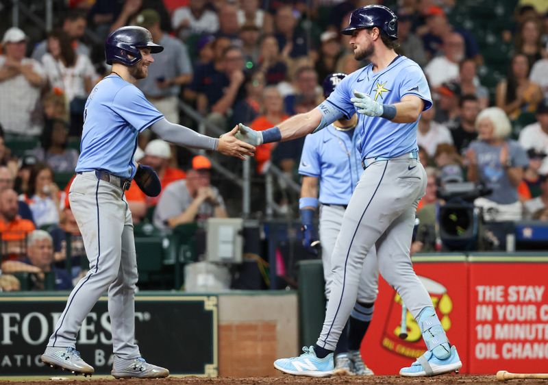 Aug 3, 2024; Houston, Texas, USA; Tampa Bay Rays right fielder Josh Lowe (right) celebrates with second baseman Brandon Lowe (left) after hitting a two run home run against the Houston Astros in the fifth inning at Minute Maid Park. Mandatory Credit: Thomas Shea-USA TODAY Sports