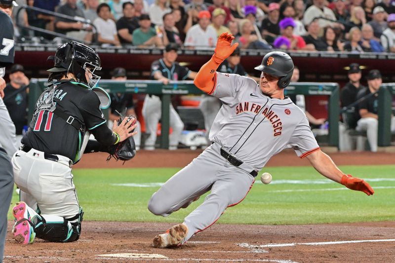 Sep 23, 2024; Phoenix, Arizona, USA;  San Francisco Giants third baseman Matt Chapman (26) slides home with an inside the park home run as Diamondbacks catcher Jose Herrera (11) defends in the third inning at Chase Field. Mandatory Credit: Matt Kartozian-Imagn Images