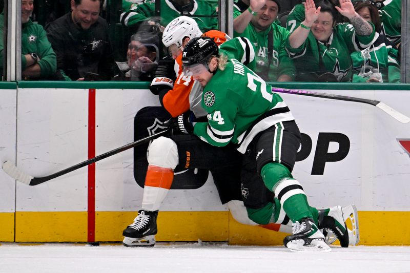 Nov 15, 2025; Dallas, Texas, USA; Philadelphia Flyers center Sean Couturier (14) and Dallas Stars center Roope Hintz (24) battle for control of the puck during the first period at the American Airlines Center. Mandatory Credit: Jerome Miron-Imagn Images