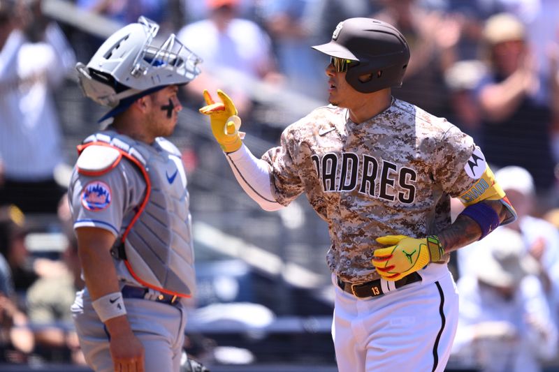 Jul 9, 2023; San Diego, California, USA; San Diego Padres third baseman Manny Machado (13) gestures after hitting a three-run home run as New York Mets catcher Francisco Alvarez (4) looks on during the first inning at Petco Park. Mandatory Credit: Orlando Ramirez-USA TODAY Sports