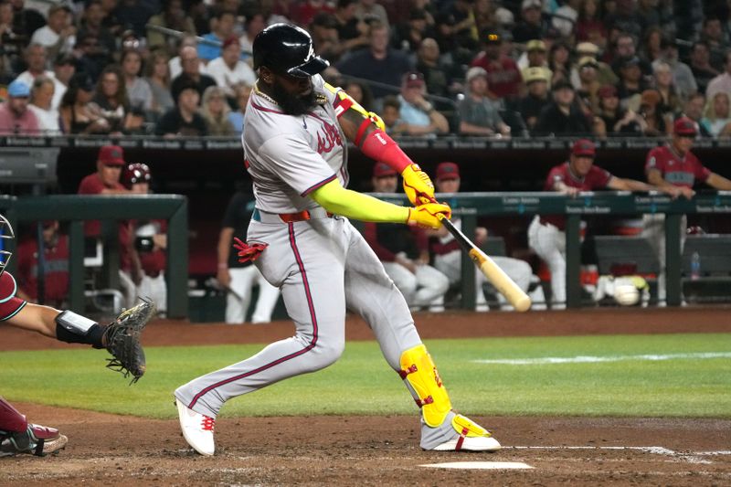 Jul 11, 2024; Phoenix, Arizona, USA; Atlanta Braves designated hitter Marcell Ozuna (20) hits a single against the Arizona Diamondbacks in the fifth inning at Chase Field. Mandatory Credit: Rick Scuteri-USA TODAY Sports