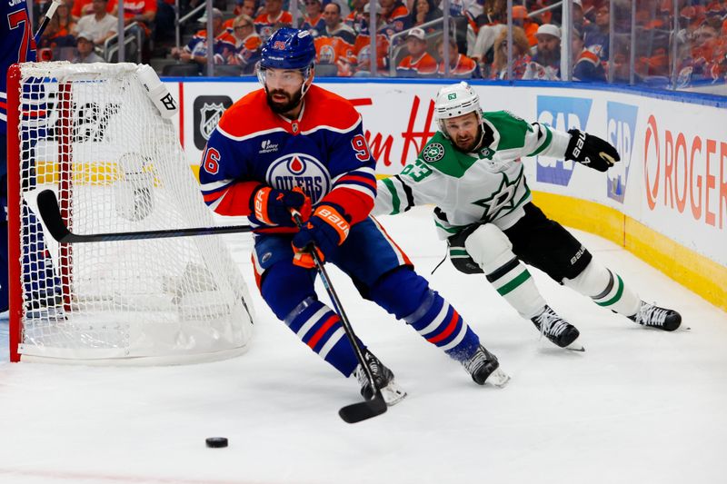 May 25, 2025; Edmonton, Alberta, CAN; Edmonton Oilers defenseman Jake Walman (96) keeps the puck away from Dallas Stars right wing Evgenii Dadonov (63) in game three of the Western Conference Final of the 2025 Stanley Cup Playoffs at Rogers Place. Mandatory Credit: Perry Nelson-Imagn Images
