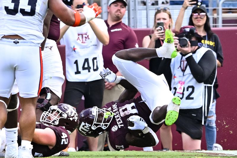 Sep 23, 2023; College Station, Texas, USA; Texas A&M Aggies running back Le'Veon Moss (8) rolls into the end zone for a touchdown during the fourth quarter against the Auburn Tigers at Kyle Field. Mandatory Credit: Maria Lysaker-USA TODAY Sports