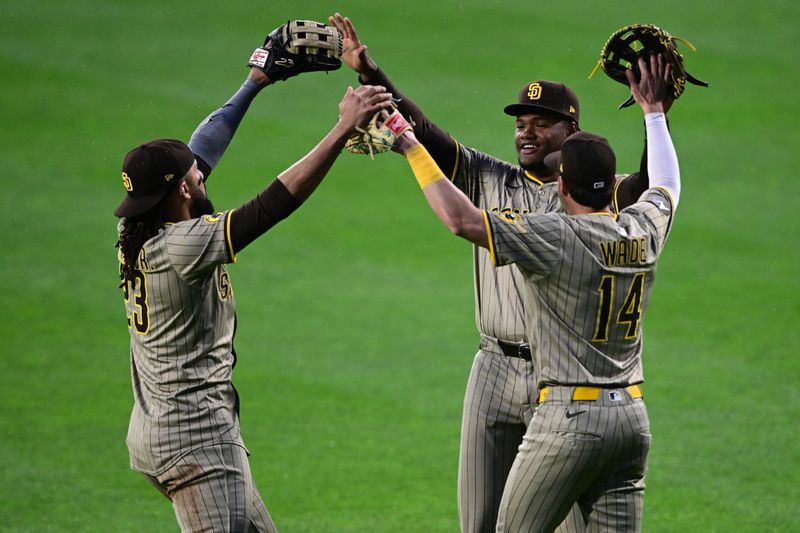 May 3, 2025; Pittsburgh, Pennsylvania, USA; San Diego Padres right fielder Fernando Tatis Jr. (23) center fielder Tyler Wade (14) and left fielder Oscar Gonzalez (39) celebrate after the Padres defeated the Pittsburgh Pirates at PNC Park. Mandatory Credit: David Dermer-Imagn Images