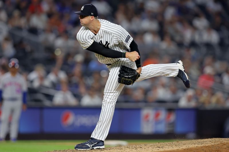 Jul 26, 2023; Bronx, New York, USA; New York Yankees relief pitcher Clay Holmes (35) follows through on a pitch against the New York Mets during the ninth inning at Yankee Stadium. Mandatory Credit: Brad Penner-USA TODAY Sports