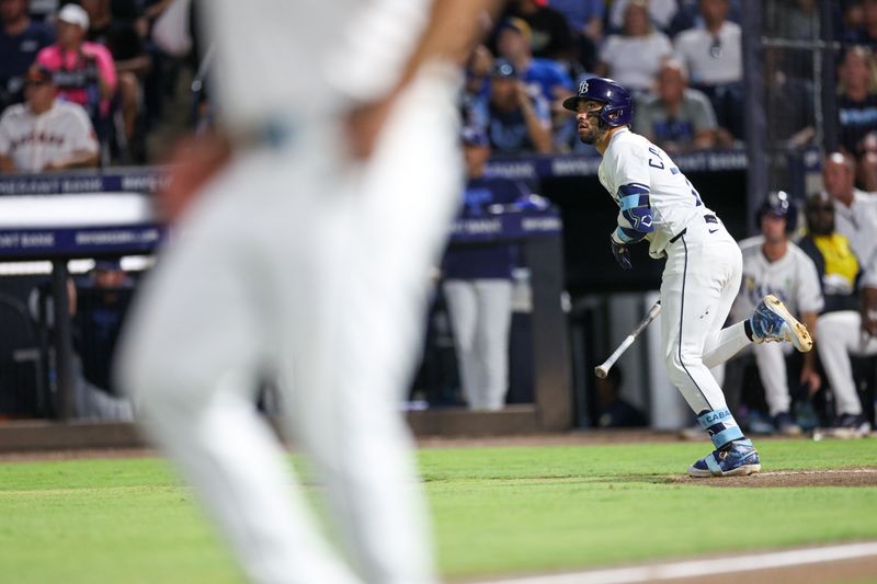 May 19, 2025; Tampa, Florida, USA; Tampa Bay Rays right fielder Jose Caballero (77) hits an rbi double against the Houston Astros in the sixth inning  at George M. Steinbrenner Field. Mandatory Credit: Nathan Ray Seebeck-Imagn Images