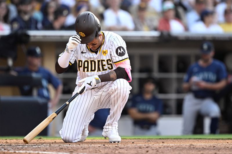 Jul 10, 2024; San Diego, California, USA; San Diego Padres designated hitter Manny Machado (13) reacts after falling while avoiding an inside pitch during the ninth inning against the Seattle Mariners at Petco Park. Mandatory Credit: Orlando Ramirez-USA TODAY Sports