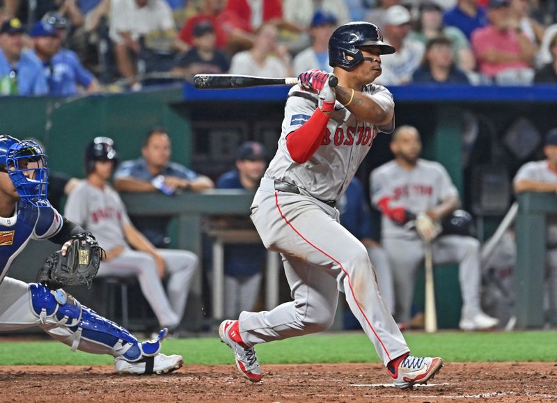 Aug 5, 2024; Kansas City, Missouri, USA;  Boston Red Sox third baseman Rafael Devers (11) singles in the seventh inning against the Kansas City Royals at Kauffman Stadium. Mandatory Credit: Peter Aiken-USA TODAY Sports