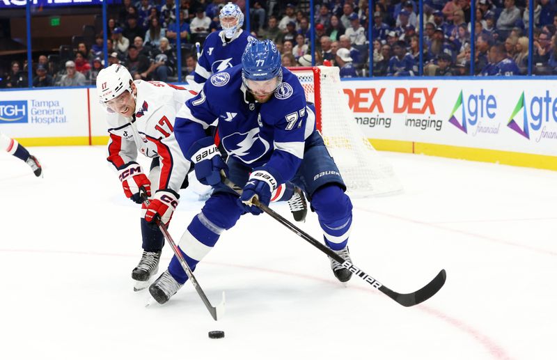 Nov 27, 2024; Tampa, Florida, USA;  Washington Capitals center Dylan Strome (17) gets called for slashing Tampa Bay Lightning defenseman Victor Hedman (77) during the second period at Amalie Arena. Mandatory Credit: Kim Klement Neitzel-Imagn Images