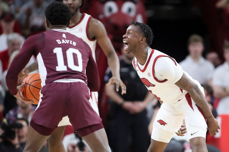 Feb 11, 2023; Fayetteville, Arkansas, USA; Arkansas Razorbacks guard Davonte Davis (4) reacts while defending Mississippi State Bulldogs guard Dashawn Davis (10) during the first half at Bud Walton Arena. Bulldogs won 70-64. Mandatory Credit: Nelson Chenault-USA TODAY Sports