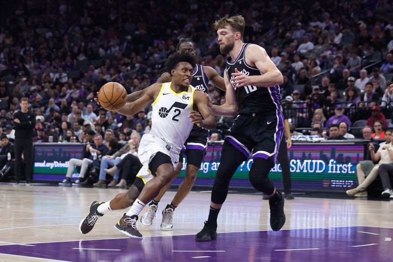 SACRAMENTO, CALIFORNIA - MARCH 31: Collin Sexton #2 of the Utah Jazz drives to the basket against Domantas Sabonis #10 of the Sacramento Kings in the second quarter at Golden 1 Center on March 31, 2024 in Sacramento, California. NOTE TO USER: User expressly acknowledges and agrees that, by downloading and or using this photograph, User is consenting to the terms and conditions of the Getty Images License Agreement. (Photo by Lachlan Cunningham/Getty Images)