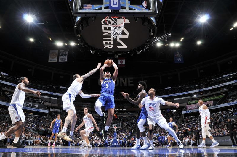 ORLANDO, FL - MARCH 29: Paolo Banchero #5 of the Orlando Magic drives to the basket during the game against the LA Clippers on March 29, 2024 at the Kia Center in Orlando, Florida. NOTE TO USER: User expressly acknowledges and agrees that, by downloading and or using this photograph, User is consenting to the terms and conditions of the Getty Images License Agreement. Mandatory Copyright Notice: Copyright 2024 NBAE (Photo by Fernando Medina/NBAE via Getty Images)