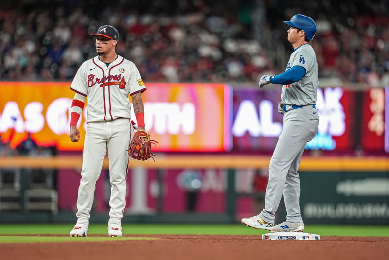 Sep 15, 2024; Cumberland, Georgia, USA; Los Angeles Dodgers designated hitter Shohei Ohtani (17) on base after hitting a double to drive in a run against the Atlanta Braves during the fifth inning at Truist Park. Mandatory Credit: Dale Zanine-Imagn Images