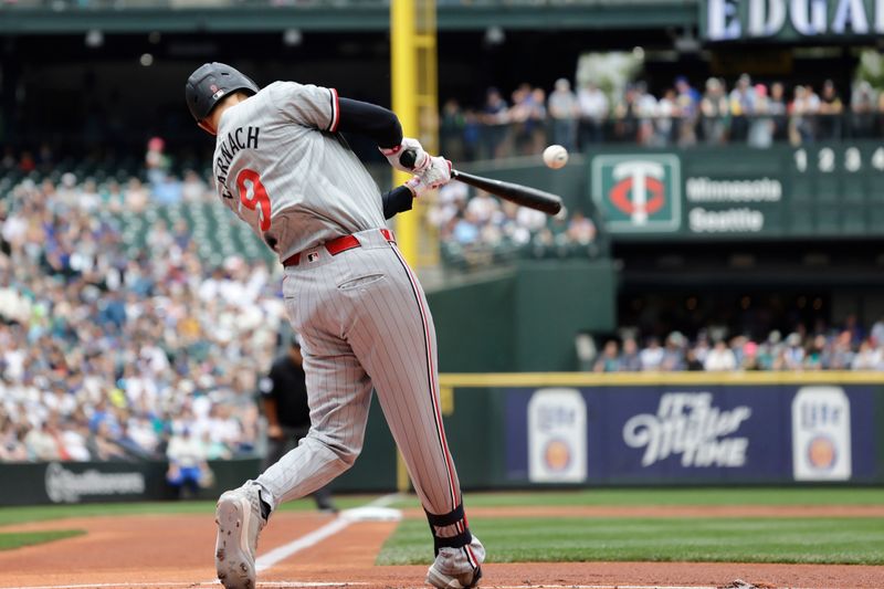 Jun 30, 2024; Seattle, Washington, USA; Minnesota Twins left fielder Trevor Larnach (9) hits a RBI single against the Seattle Mariners during the first inning at T-Mobile Park. Mandatory Credit: John Froschauer-USA TODAY Sports