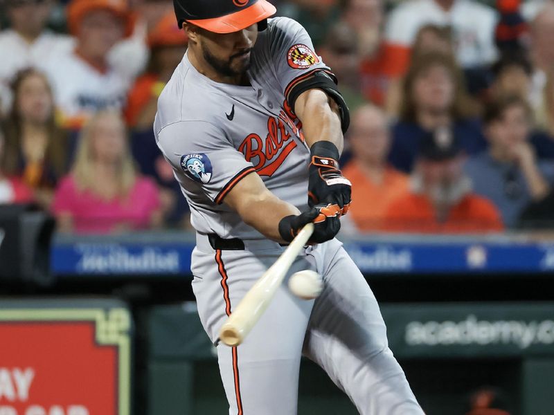 Jun 23, 2024; Houston, Texas, USA;  Baltimore Orioles right fielder Anthony Santander (25) hits a single against the Houston Astros in the first inning at Minute Maid Park. Mandatory Credit: Thomas Shea-USA TODAY Sports